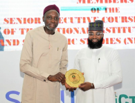 L-R: The Director General, National Institute for Policy and Strategic Studies (NIPSS) Kuru, Prof. Ayo Omotayo presenting an Award to the Executive Vice Chairman/CEO of National Agency for Science and Engineering Infrastructure (NASENI), Mr. Khalil Suleiman Halilu during a study tour of the Senior Executive Course 46 at the NASENI Headquarters Abuja  today, Monday 15th April, 2024.