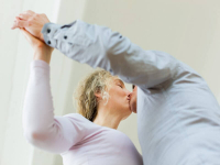  *  An older couple share a kiss as they dance together.